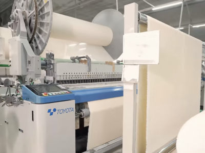Air jet loom weaving cotton towel fabric in Vietnam manufacturing factory
